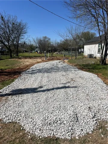 a view of a backyard with large trees