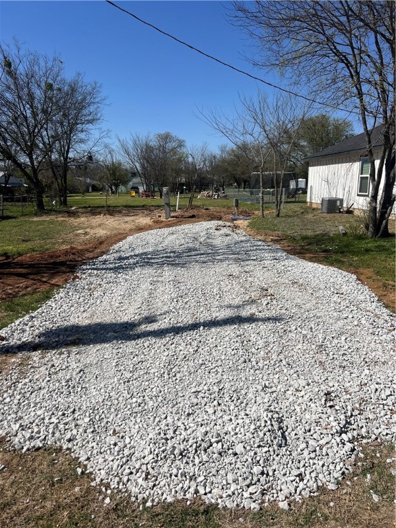 a view of a backyard with large trees
