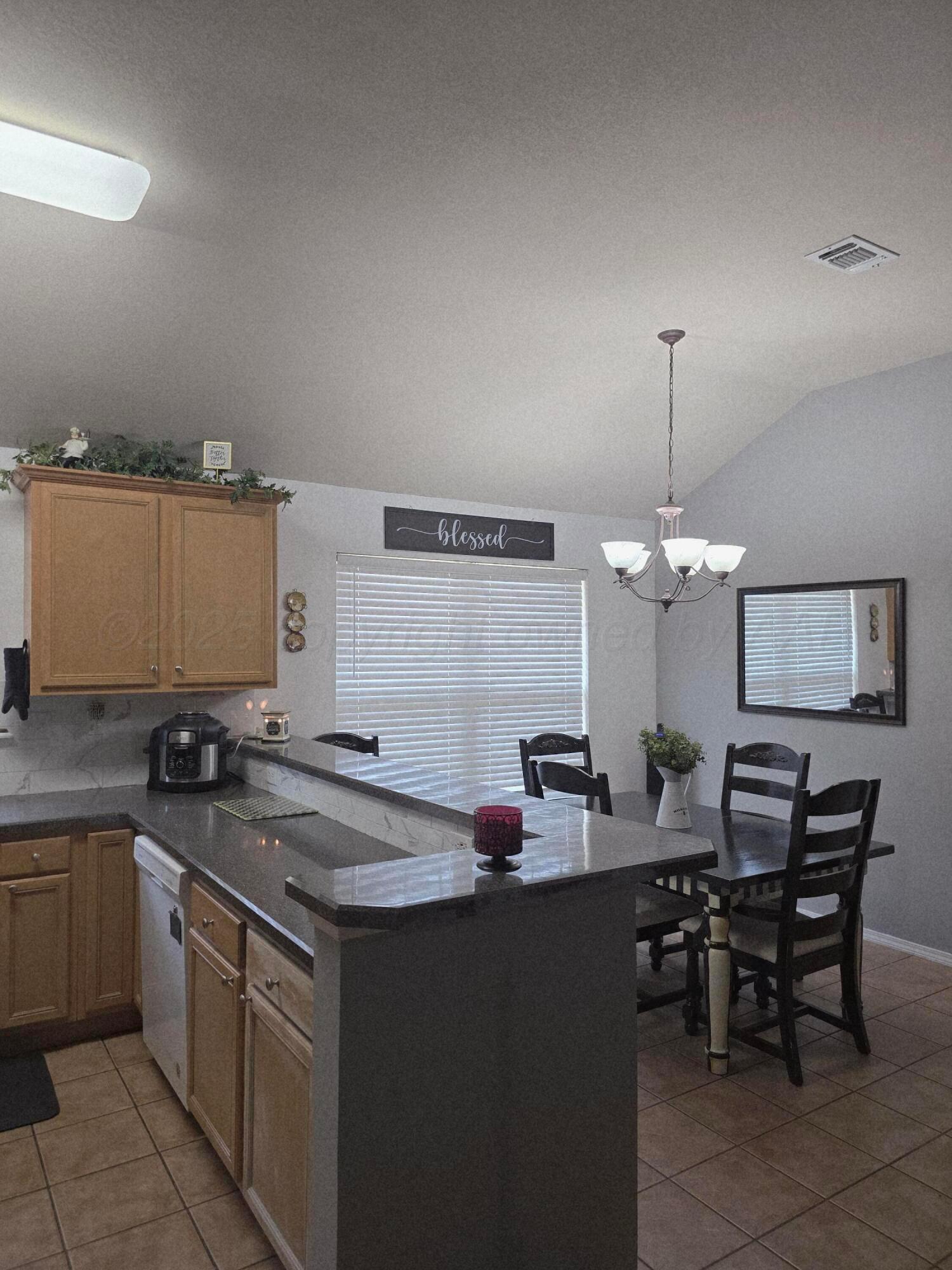 4808 Mammoth Lane Amarillo, TX 79110 - Photo 4 of 15 a kitchen with a sink and chairs