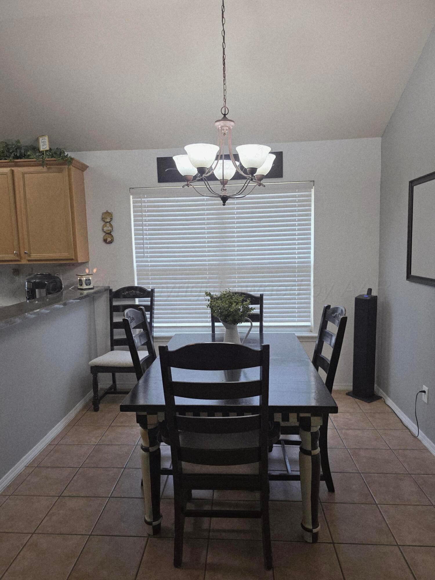 4808 Mammoth Lane Amarillo, TX 79110 - Photo 5 of 15 a view of a dining room with furniture and chandelier