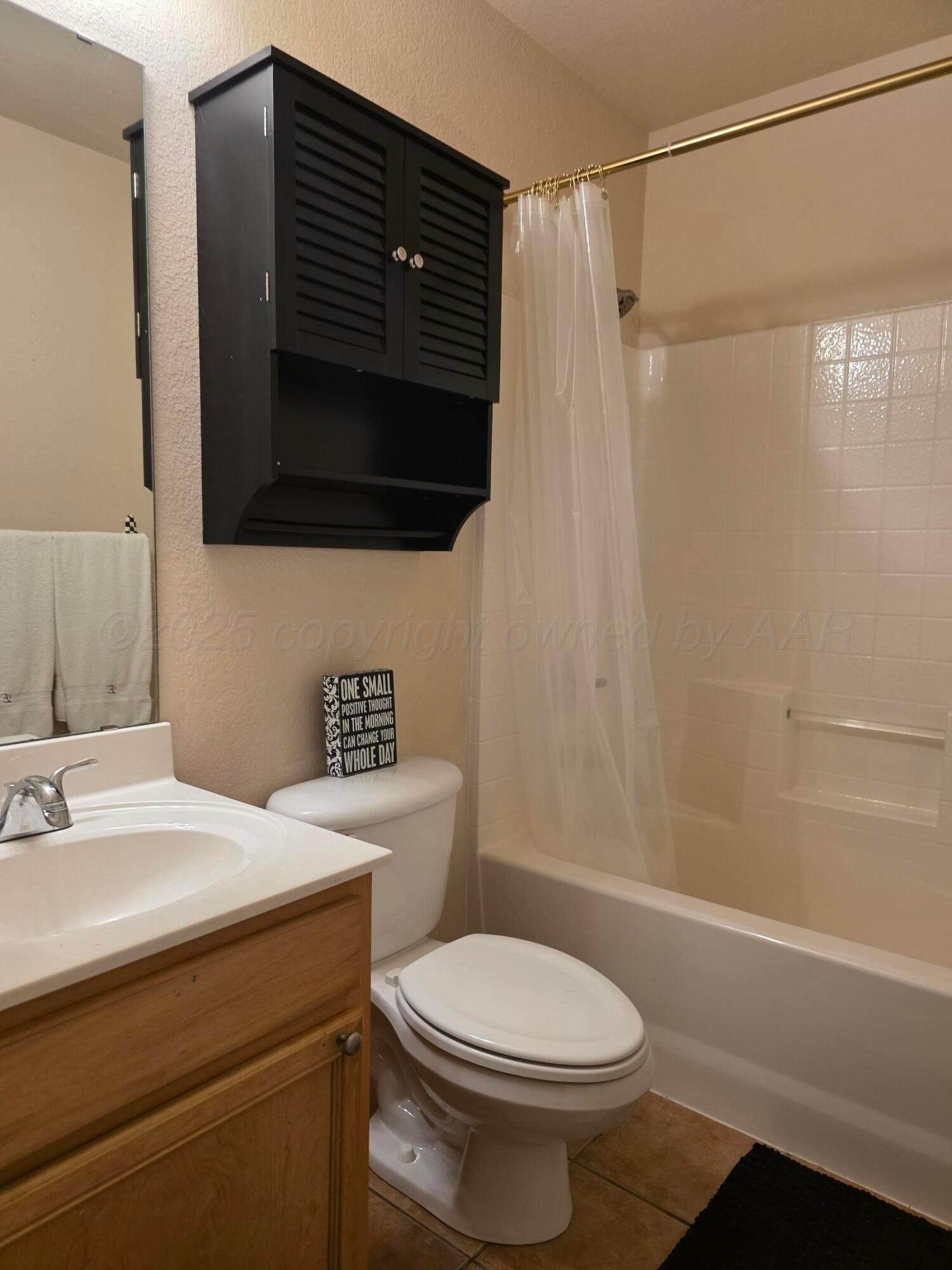 4808 Mammoth Lane Amarillo, TX 79110 - Photo 9 of 15 a bathroom with a sink a toilet and shower