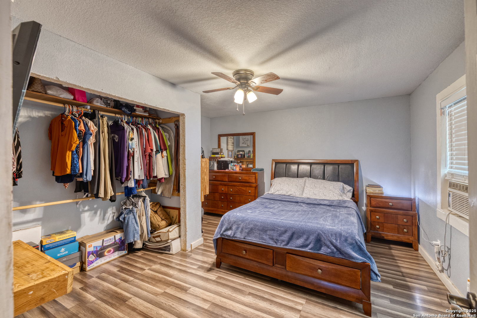 806 South Park Street Uvalde, TX 78801 - Photo 14 of 25 a bedroom with a bed and a walk in closet