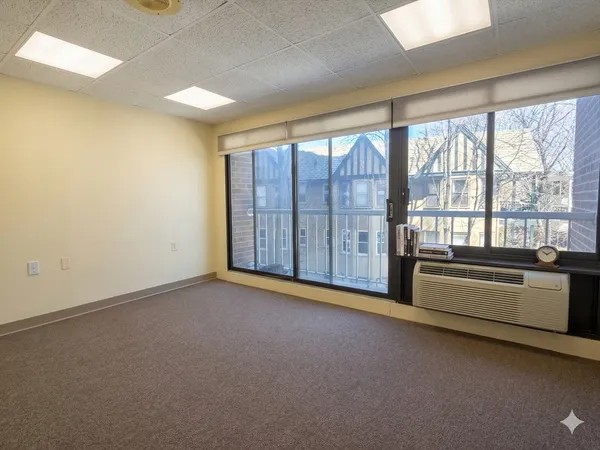 an empty room with furniture and windows