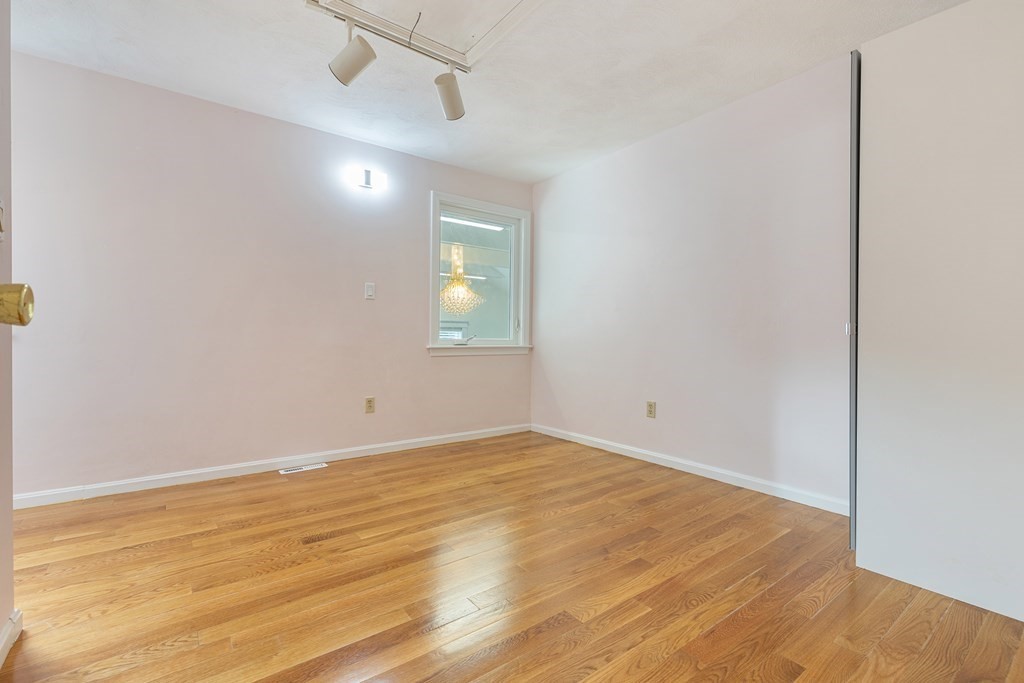 28 Standish Road Needham, MA 02492 - Photo 16 of 29 an empty room with a window and wooden floor