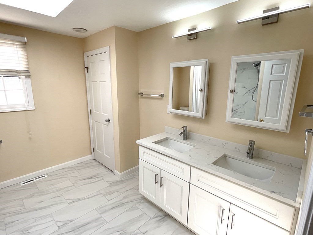 28 Standish Road Needham, MA 02492 - Photo 17 of 29 a spacious bathroom with a double vanity sink and mirror