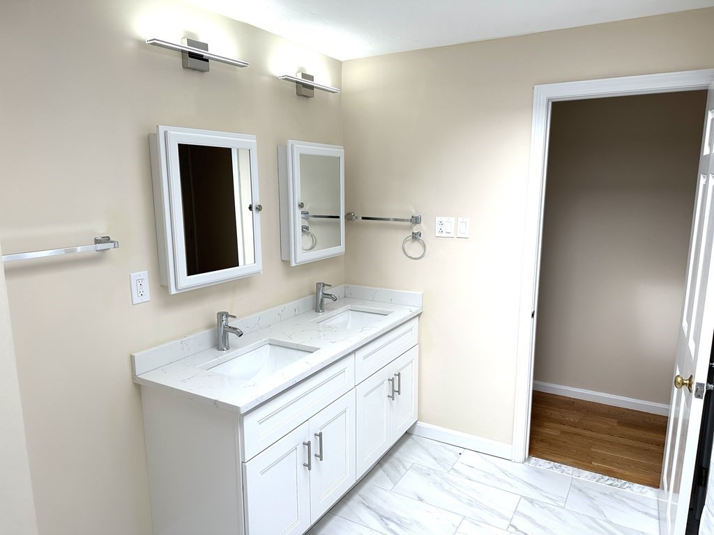 28 Standish Road Needham, MA 02492 - Photo 19 of 29 a bathroom with a double vanity sink and mirror