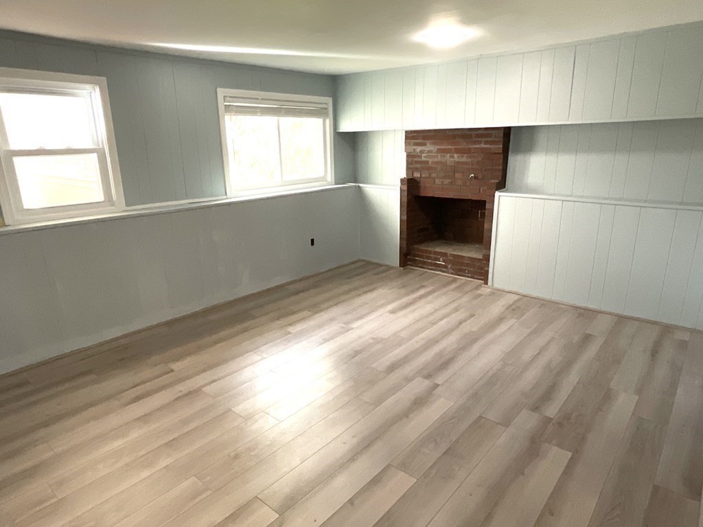 28 Standish Road Needham, MA 02492 - Photo 20 of 29 a view of an empty room with a window and a fireplace