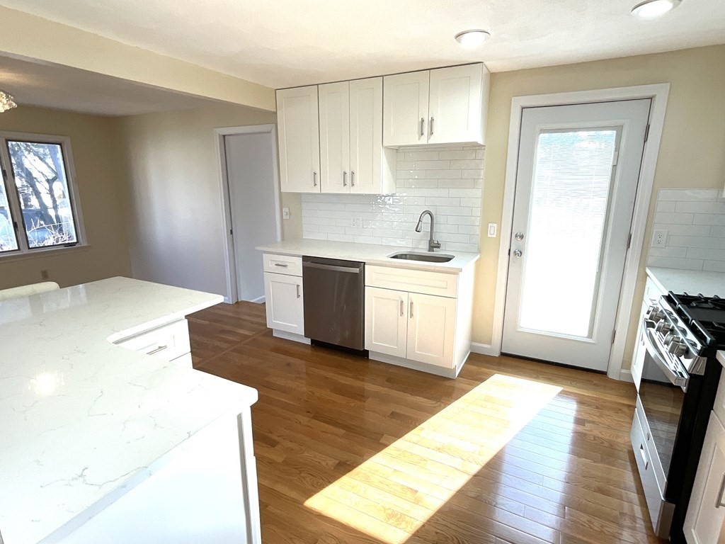 28 Standish Road Needham, MA 02492 - Photo 8 of 29 a large kitchen with a stove a sink and a refrigerator