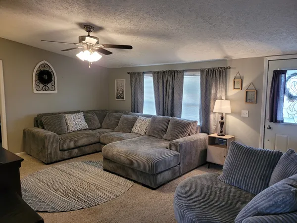 a living room with furniture and a large window