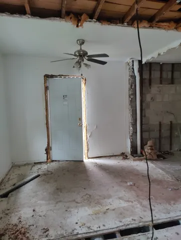 a room with water heater and a cabinet door
