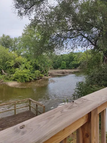 a blue swimming pool with a lake view