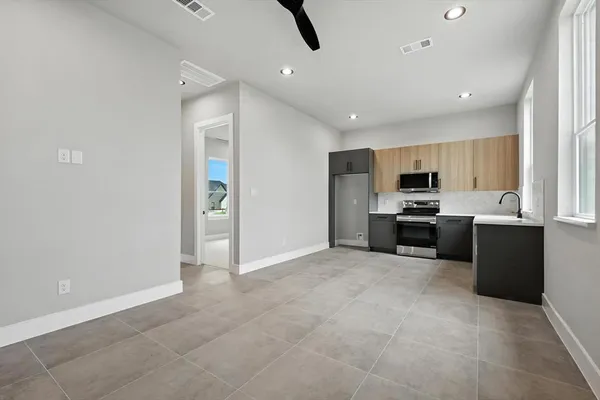 a large kitchen with cabinets and stainless steel appliances
