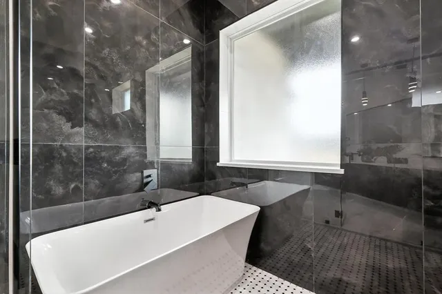 a bathroom with a bathtub and a sink