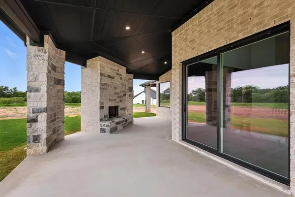 a view of a porch with furniture and a yard