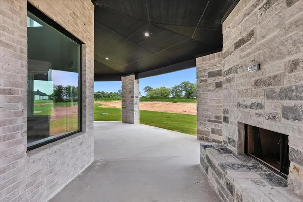 a view of an empty room with a fireplace and a floor to ceiling window