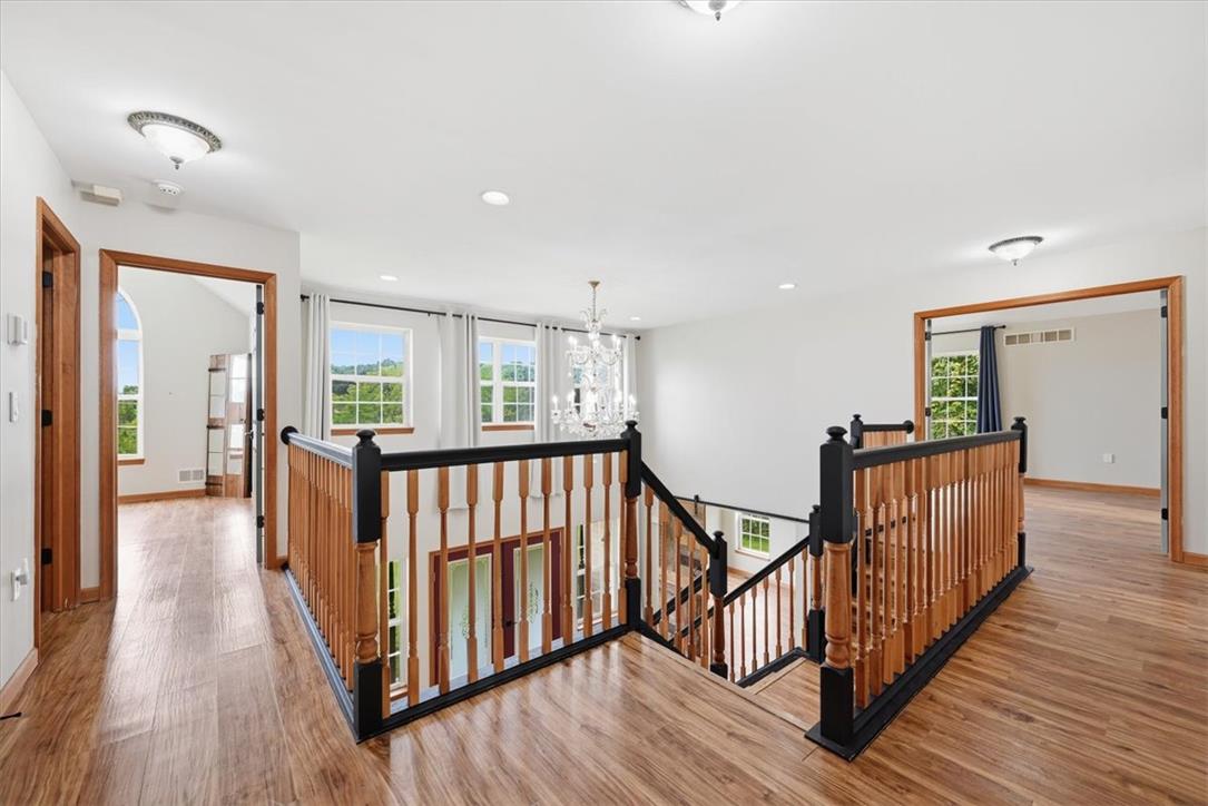 387 Blue Ridge Road Saylorsburg, PA 18353 - Photo 37 of 90 A grand central staircase connects levels in this brightly illuminated foyer.