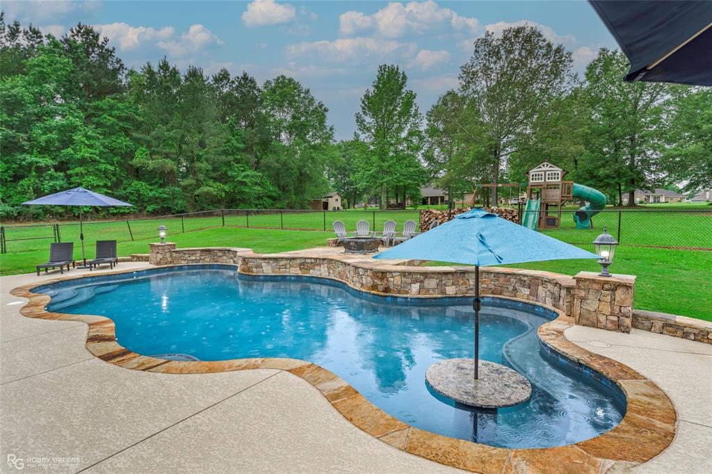 8400 Greenwood Springridge Road Greenwood, LA 71033 - Photo 1 of 1 a view of a swimming pool with a patio