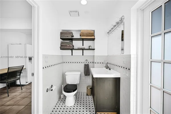 a bathroom with a bathtub sink vanity and mirror