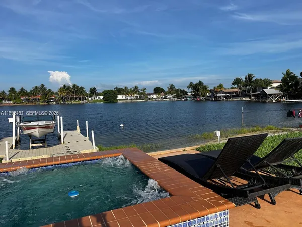 a view of a lake with a lounge chair