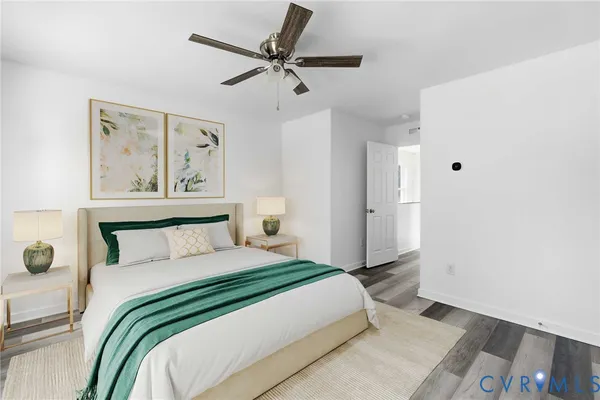 a bedroom with a large bed and a painting on the wall