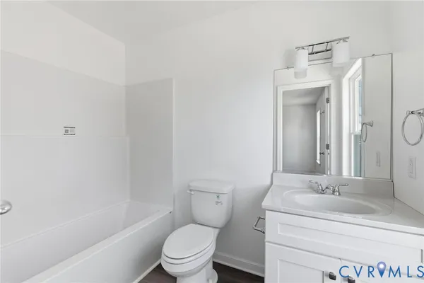 a bathroom with a granite countertop toilet a sink and a bathtub