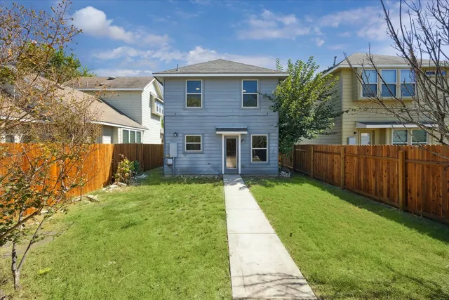 a view of a brick house with a yard