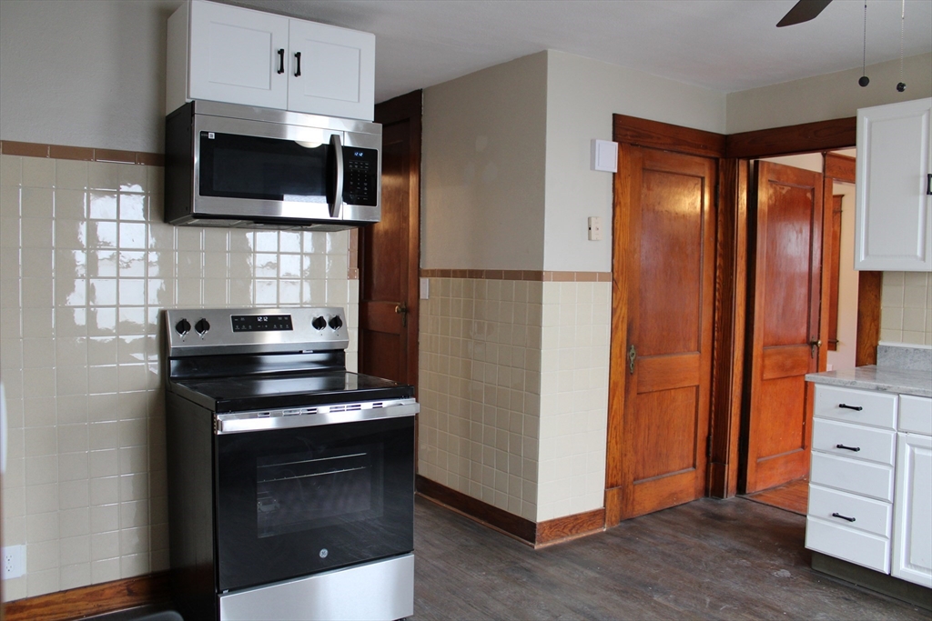 32 Kent Road Springfield, MA 01129 - Photo 3 of 30 a kitchen with stainless steel appliances a refrigerator stove and microwave