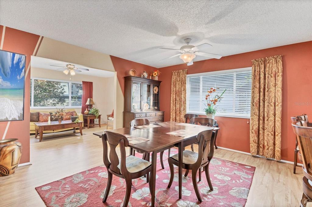 3947 Panola Lane, Unit 180 Sarasota, FL 34232 - Photo 14 of 49 a dining room with furniture a rug and a chandelier