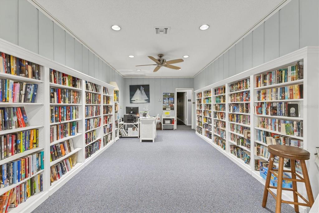 3947 Panola Lane, Unit 180 Sarasota, FL 34232 - Photo 34 of 49 a living room with furniture and a book shelf