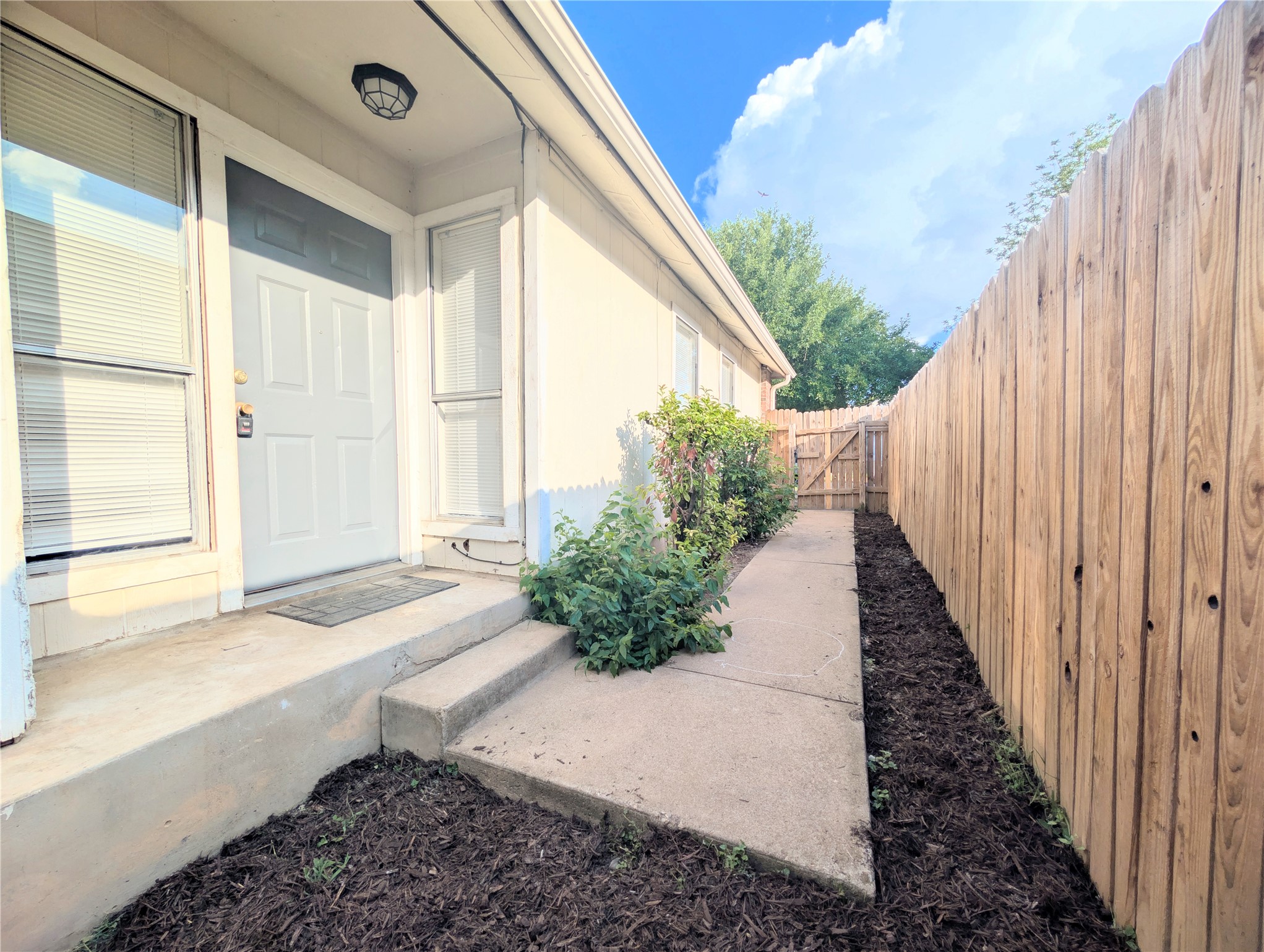2016 Redwing Way Round Rock, TX 78664 - Photo 2 of 19 A private entry leads to a welcoming home, featuring a secure wooden fence.