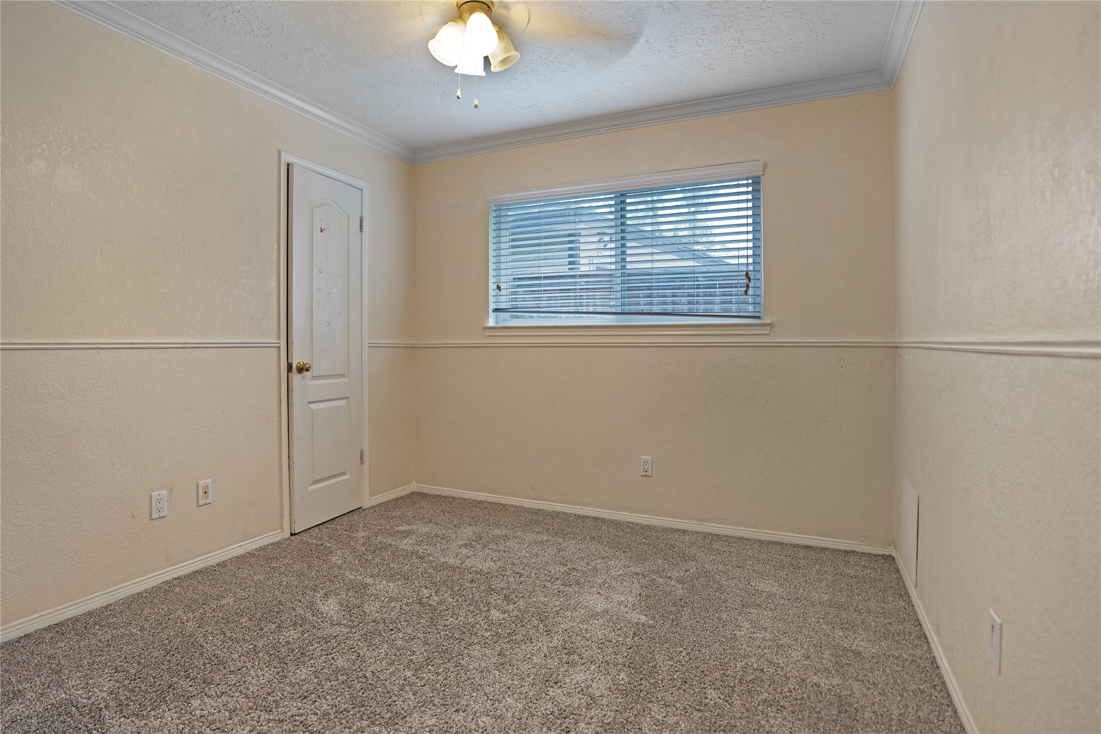 17119 Mellow Ridge Drive Spring, TX 77379 - Photo 21 of 32 This cozy room features neutral walls, soft carpet, a window with blinds for natural light, and a ceiling light fixture. It's ideal for a small bedroom or home office.