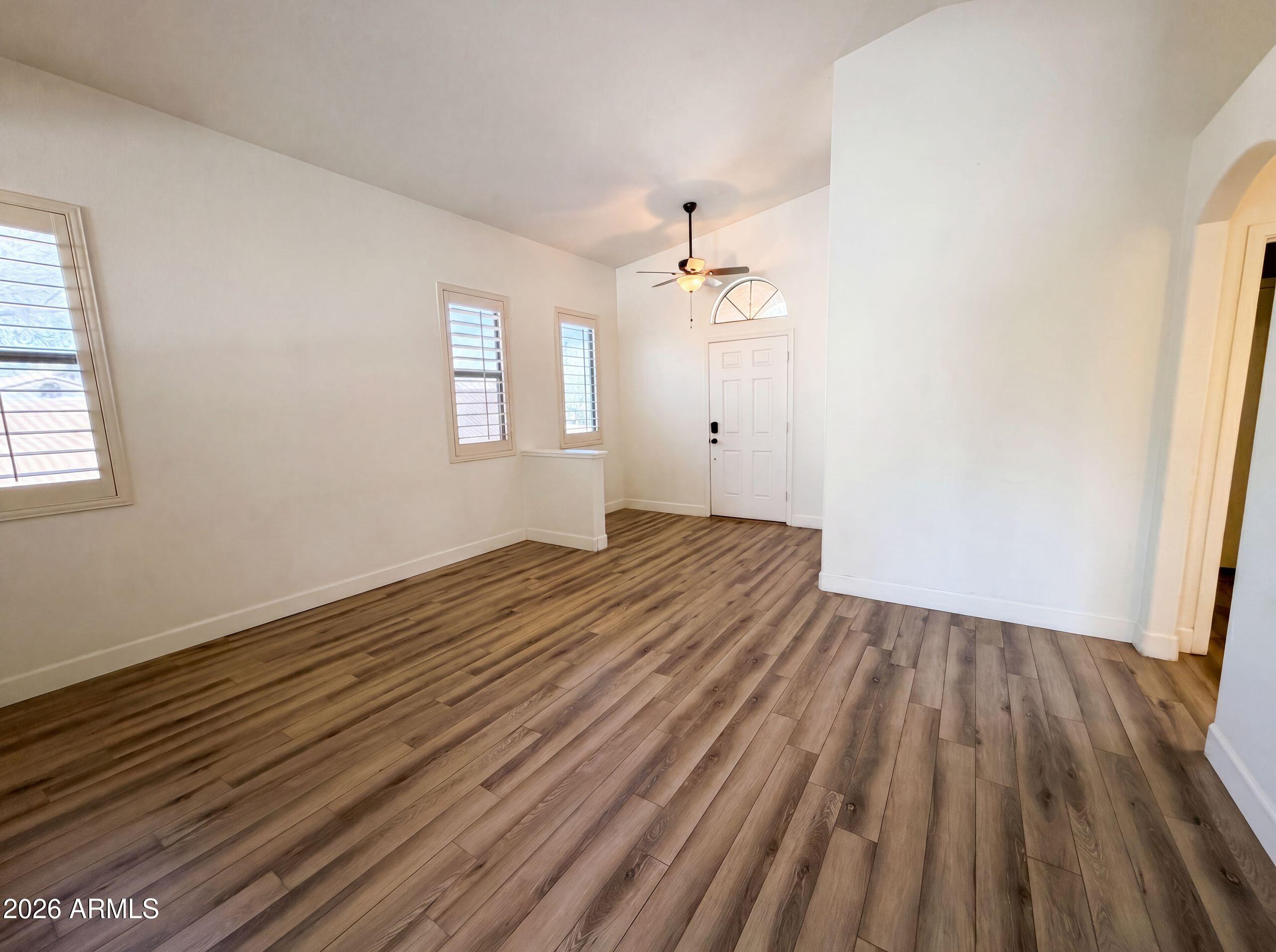3951 East Timberline Road Gilbert, AZ 85297 - Photo 13 of 28 wooden floor in an empty room with a window