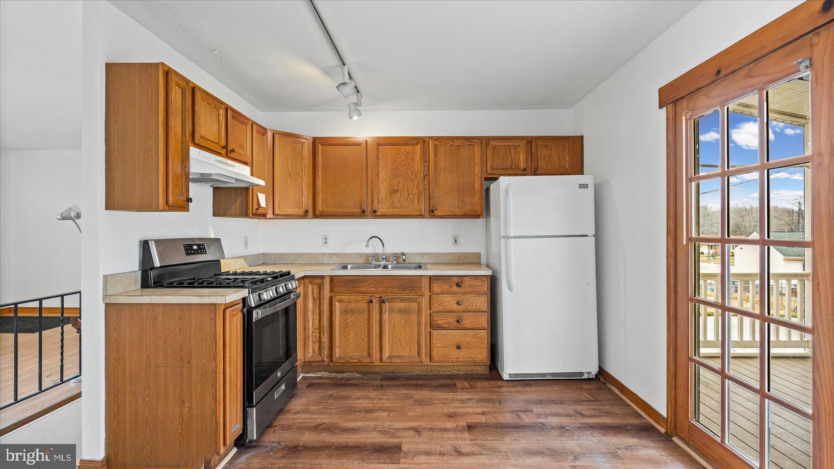 1802 Larch Drive Edgewood, MD 21040 - Photo 11 of 33 a kitchen with a refrigerator a stove a sink dishwasher and wooden cabinets