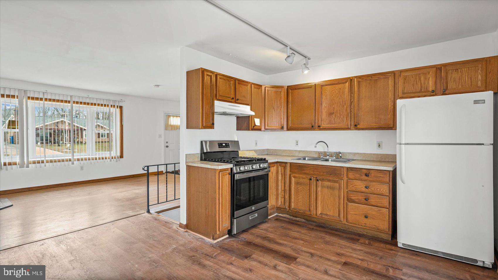 1802 Larch Drive Edgewood, MD 21040 - Photo 10 of 33 a kitchen with stainless steel appliances granite countertop a refrigerator sink and wooden cabinets