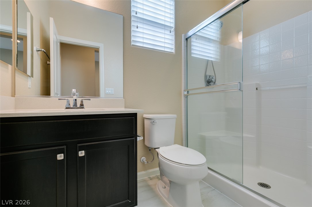 2549 Sable Ridge Street Henderson, NV 89044 - Photo 33 of 48 Modern bath offering a sleek vanity and a pristine walk-in shower with clear glass enclosure.