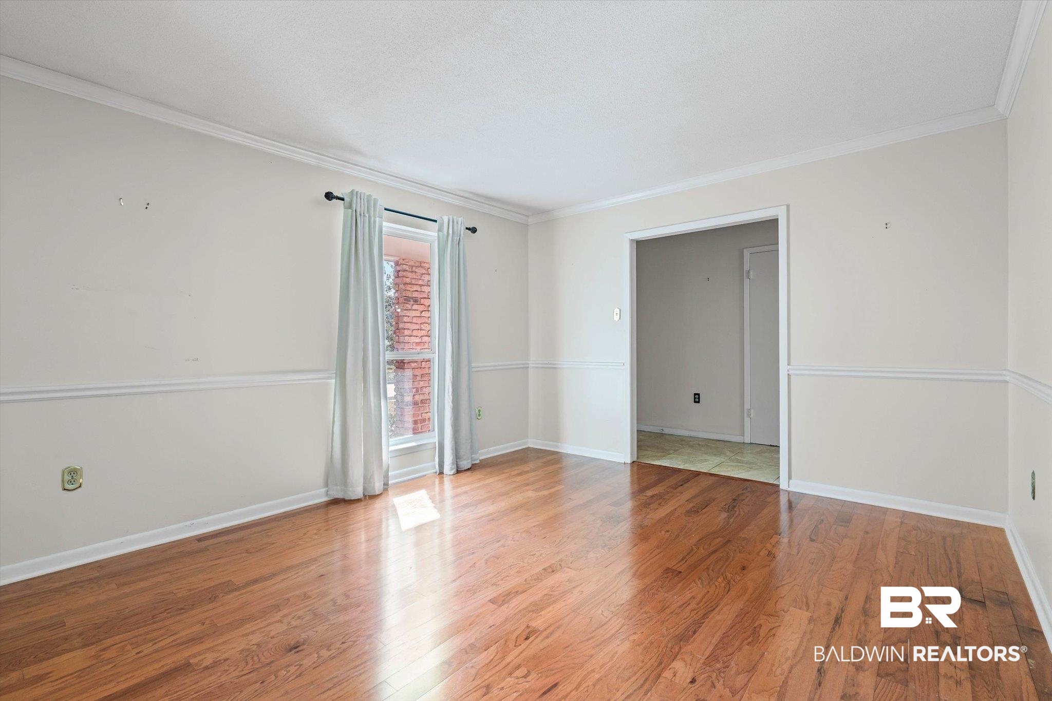 6300 Christopher Drive North Mobile, AL 36609 - Photo 4 of 22 Spare room with ornamental molding and wood finished floors