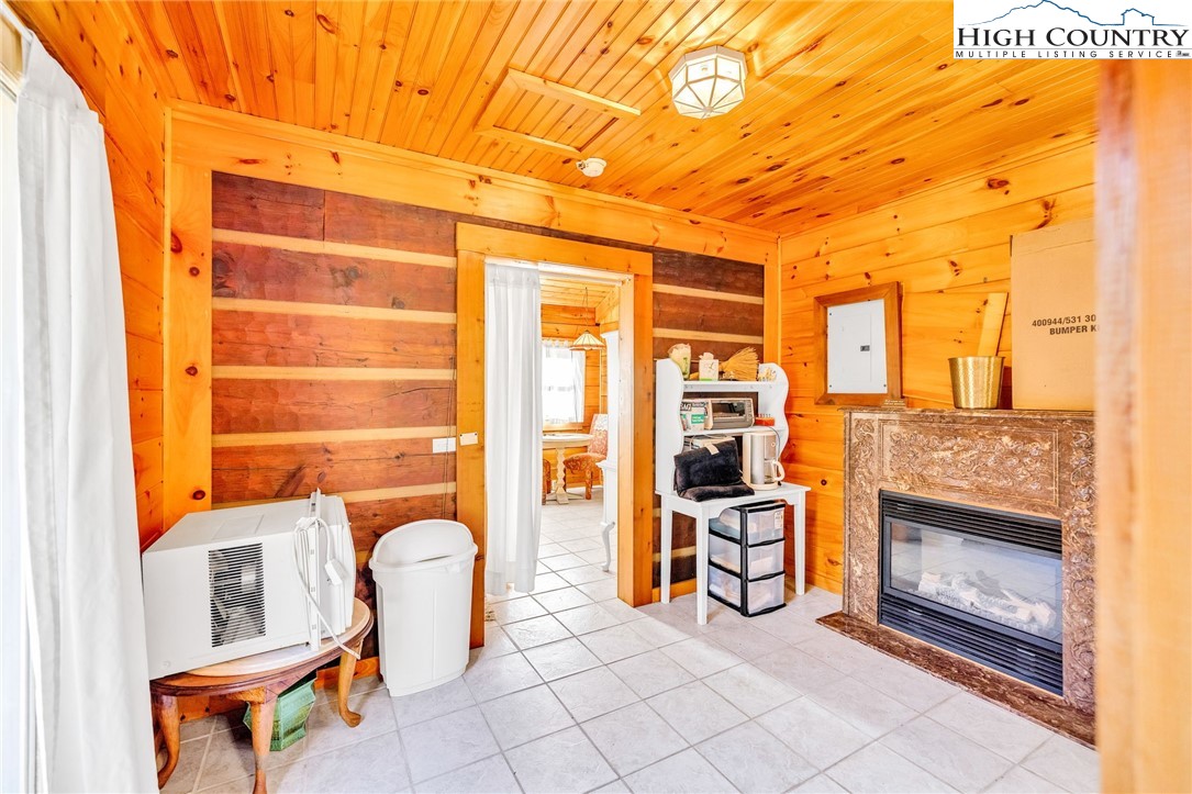 1451 Elliott Road West Jefferson, NC 28694 - Photo 14 of 33 a dining room with furniture and a fireplace