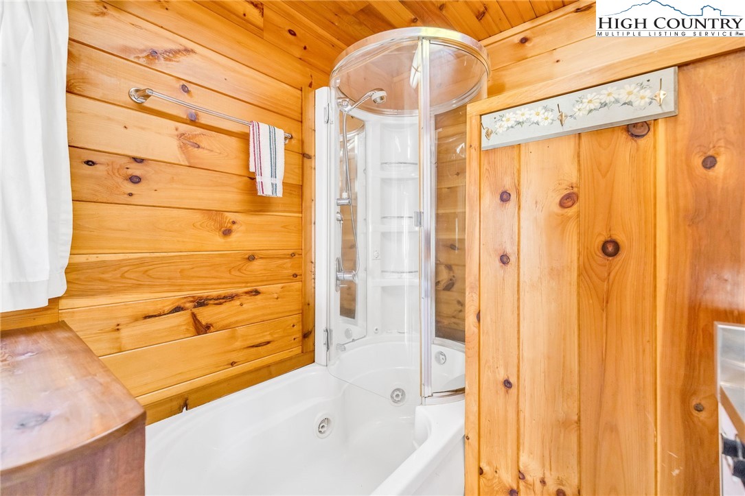 1451 Elliott Road West Jefferson, NC 28694 - Photo 19 of 33 a bathroom with a bathtub and shower
