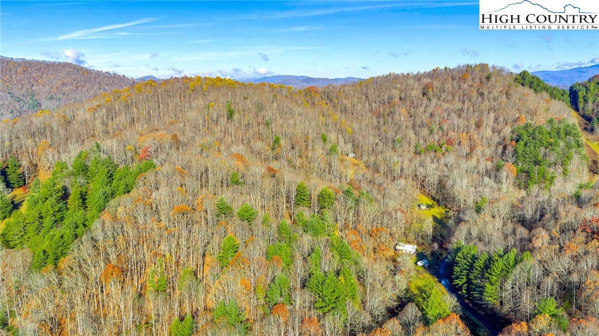 1451 Elliott Road West Jefferson, NC 28694 - Photo 27 of 33 a view of a dry yard with mountains in the background
