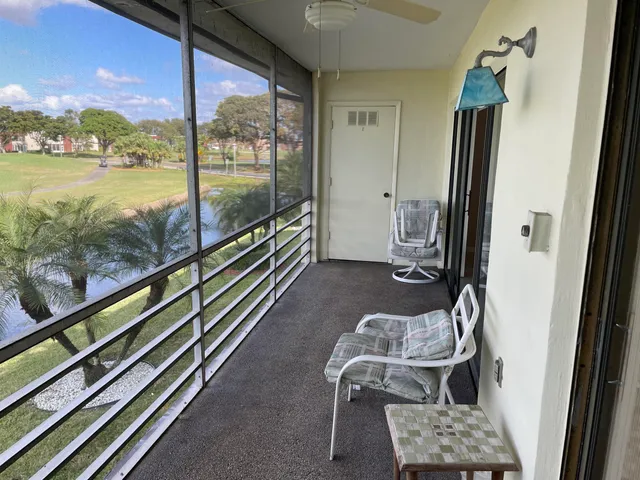 a view of a balcony with chair and floor to ceiling window