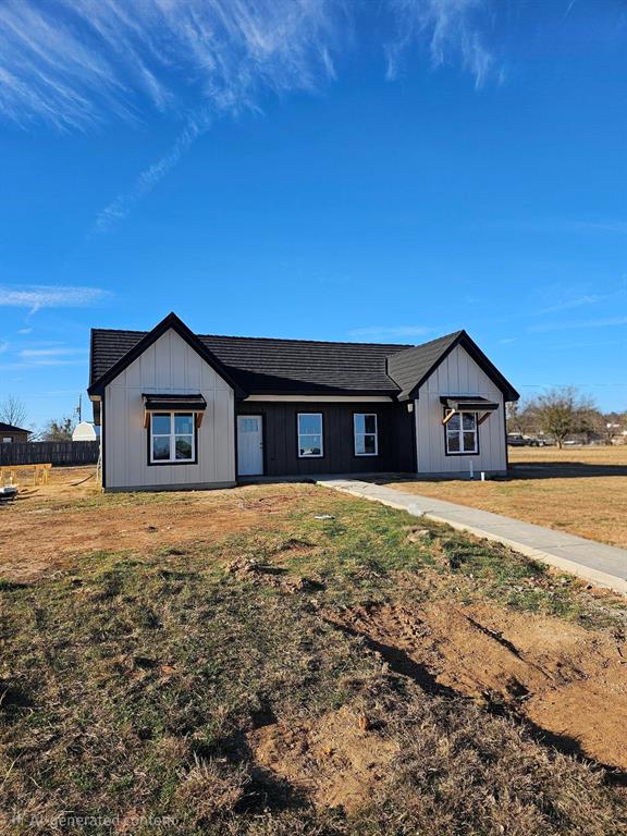 a large house with a big yard and large tree