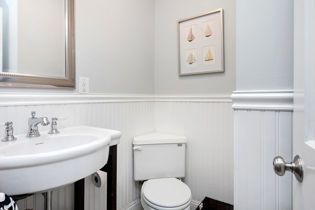 24 Montgomery Street, Unit 1 Boston, MA 02116 - Photo 12 of 15 a bathroom with a toilet a sink and mirror