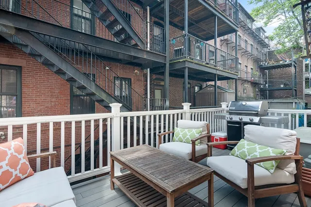 a view of a chair and tables in the balcony