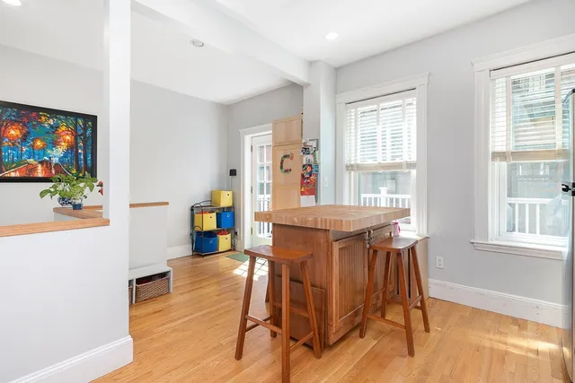 a dining room with furniture and wooden floor