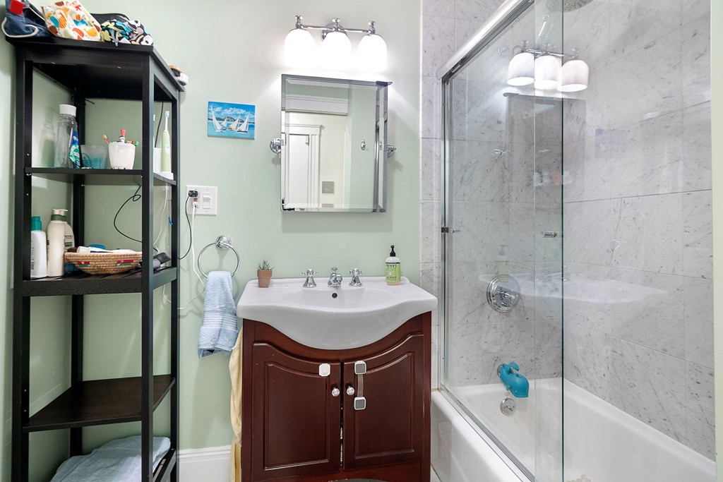 24 Montgomery Street, Unit 1 Boston, MA 02116 - Photo 8 of 15 a bathroom with a sink and a mirror