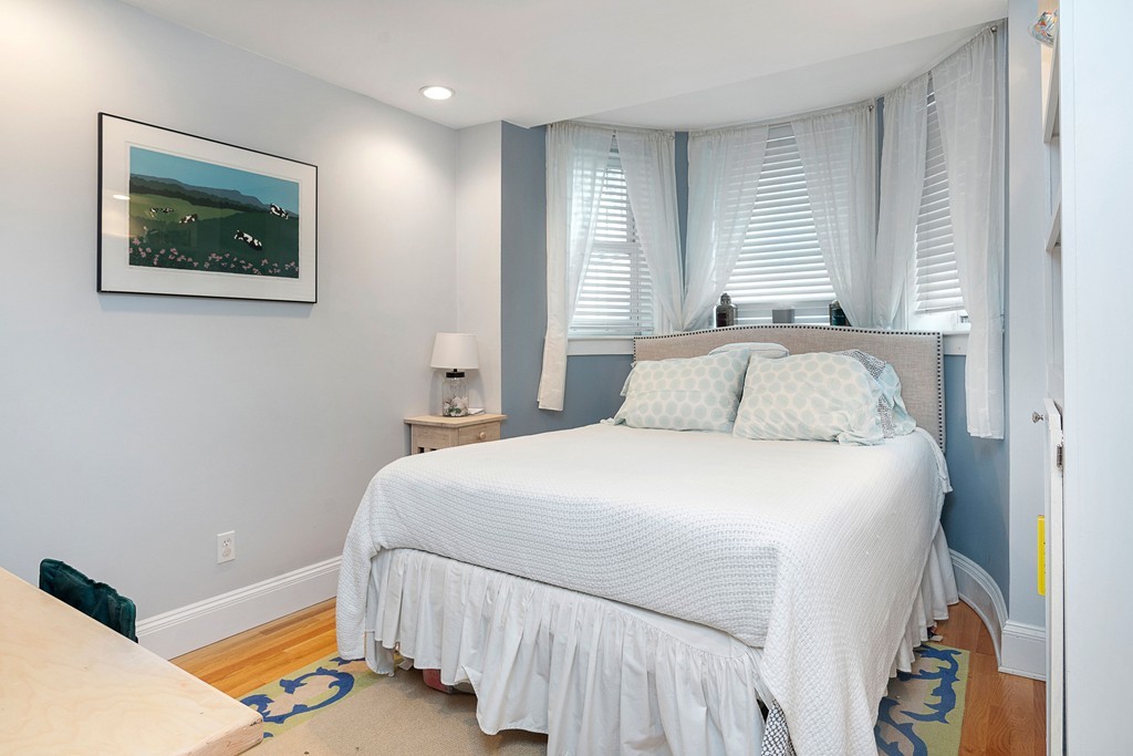 24 Montgomery Street, Unit 1 Boston, MA 02116 - Photo 9 of 15 a bedroom with a bed and a lamp