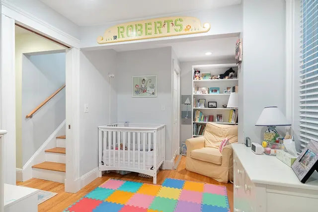 a bedroom with furniture and a rug