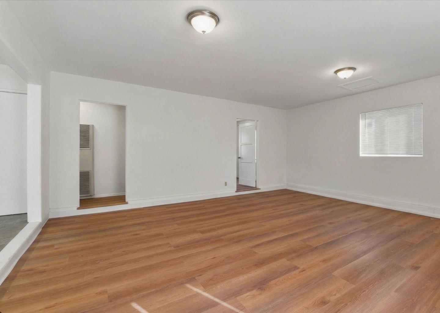 18601 Keswick Street, Unit B Reseda, CA 91335 - Photo 12 of 16 a view of an empty room with wooden floor and a window