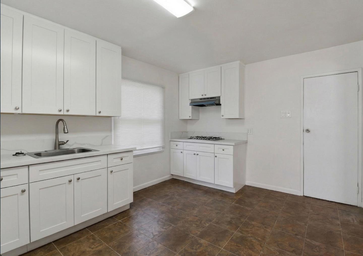 18601 Keswick Street, Unit B Reseda, CA 91335 - Photo 13 of 16 a kitchen with sink cabinets and window
