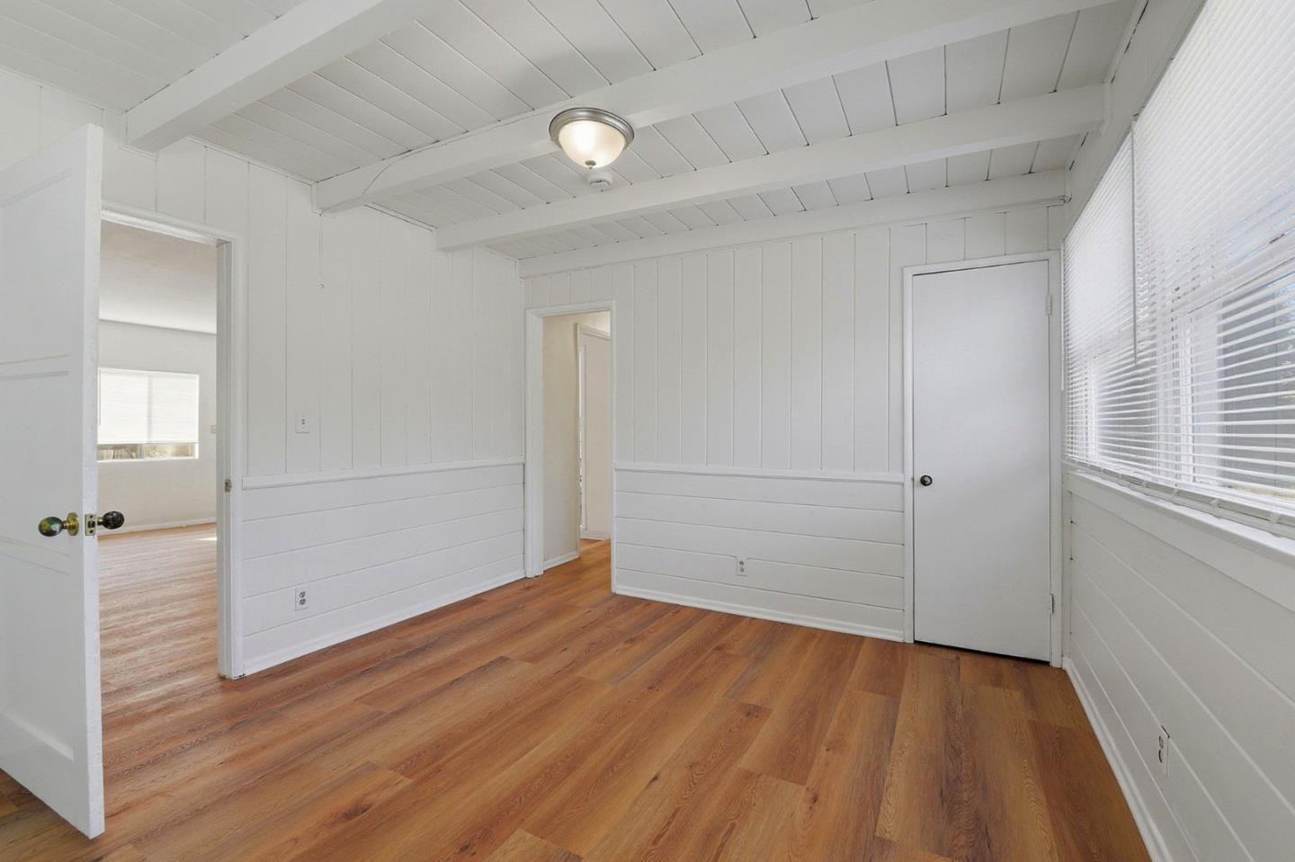 18601 Keswick Street, Unit B Reseda, CA 91335 - Photo 3 of 16 an empty room with wooden floor and windows